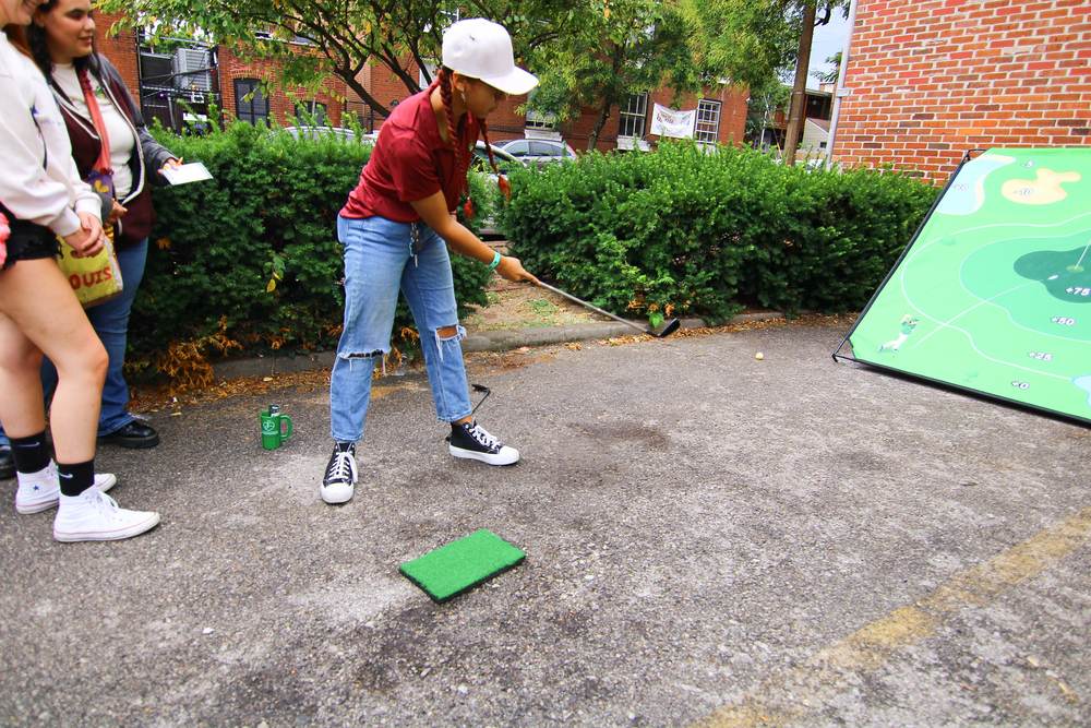 Attendee playing golf mini-game at a TGG hole
